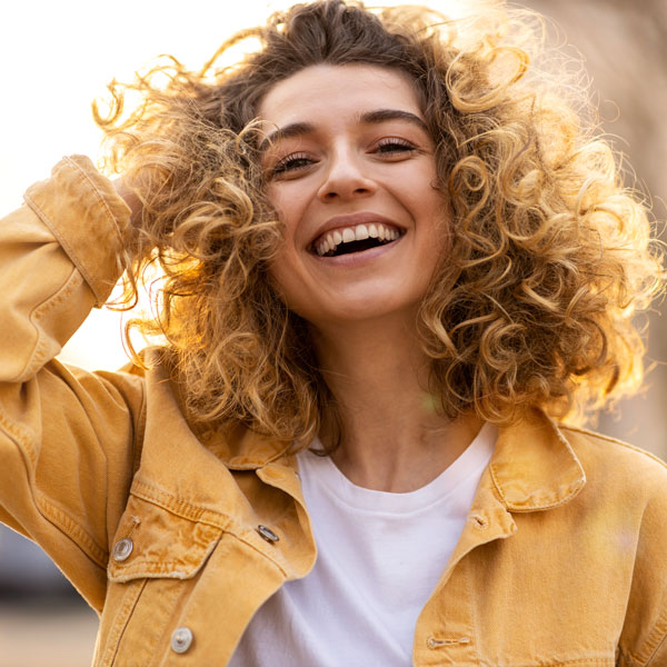 woman in yellow smiling