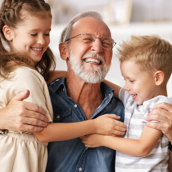 senior man with grandchildren smiling