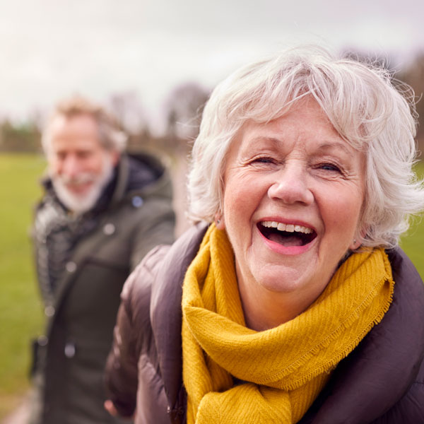 senior couple smiling on a walk