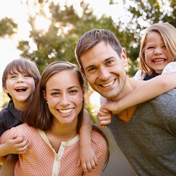 young couple and children smiling